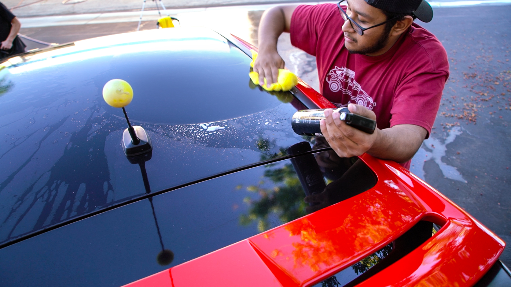 Photo: Christian - @premiumchristian /// In Photo: John - @johnnee_stunami /// John wiping off Premium Auto Styling Wrap Quick Detailer and experiences the difference it makes on his freshly washed roof wrap.