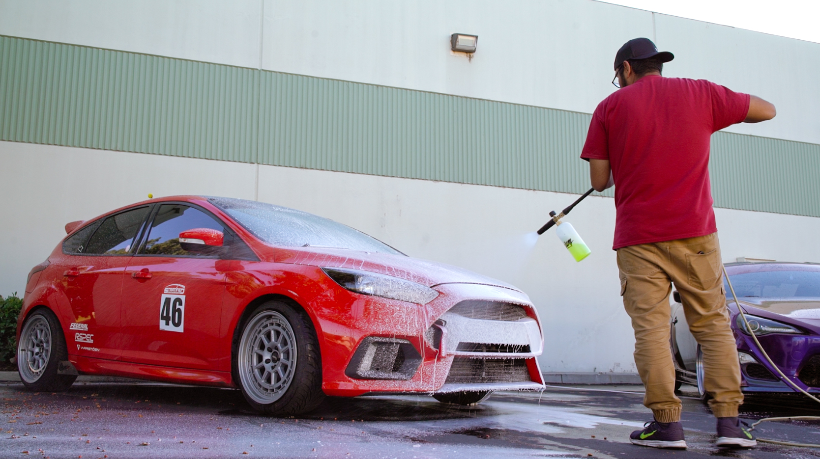 Photo: Christian - @premiumchristian /// In Photo: Center - John @johnnee_stunami /// Focus ST Owner experiencing the foam cannon for the first time while washing his vehicle with Premium Auto Styling Wrap Shampoo.